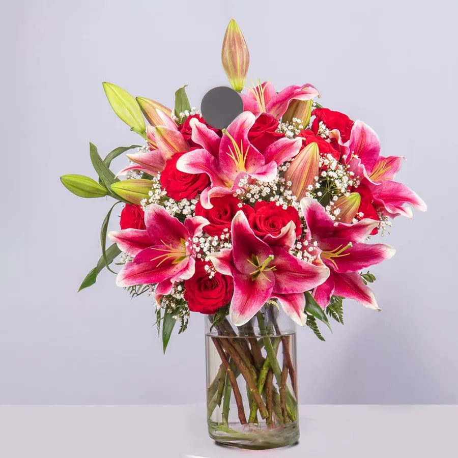 Elegant vase filled with 29 pink lilies and roses, perfect for expressing love.