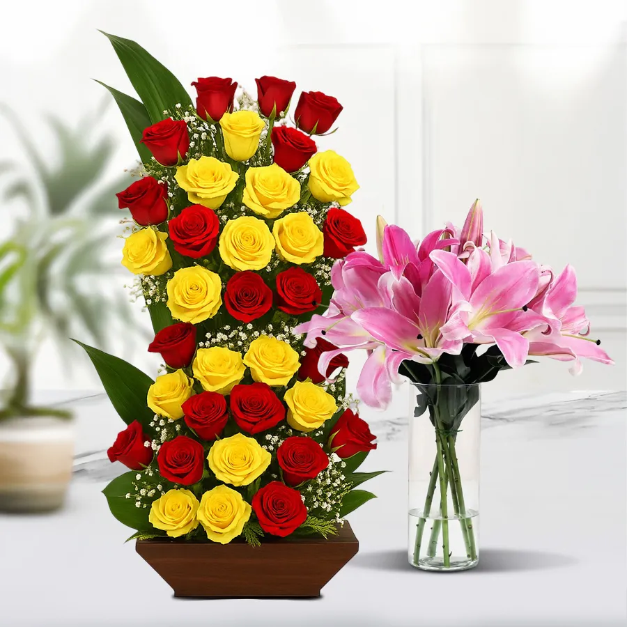 King-size mixed flower arrangement with red and yellow roses, pink lilies in a decorative vase. Perfect for celebrations and special occasions.