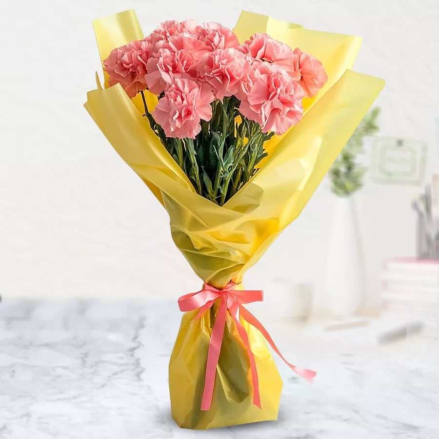 Tissue-wrapped bouquet featuring 15 charming pink carnations, perfect for expressing affection.