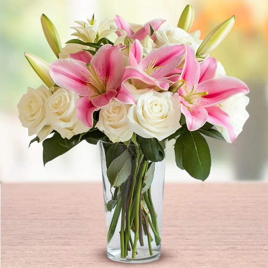 Elegant display of 15 white roses and 5 pink Oriental lilies in a glass vase, perfect for gifting on special occasions.