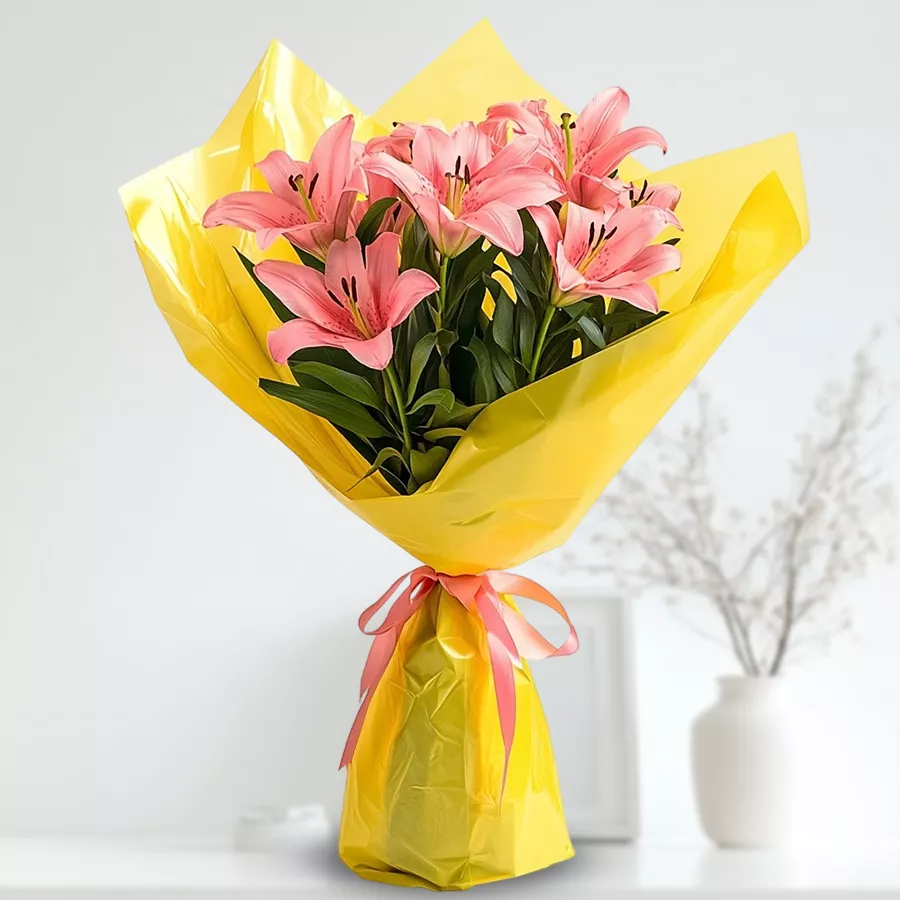 A bouquet of six pink Asiatic lilies elegantly wrapped in tissue, perfect for gifting.