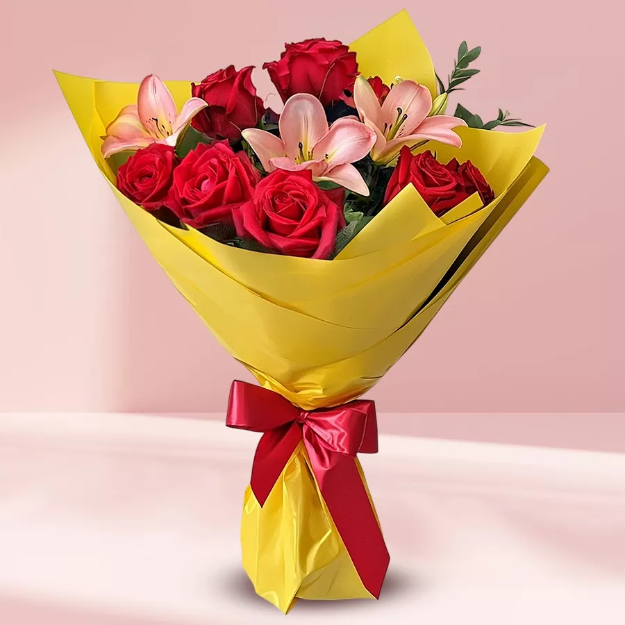 Beautiful bouquet featuring 12 roses and 3 lilies wrapped in soft tissue.