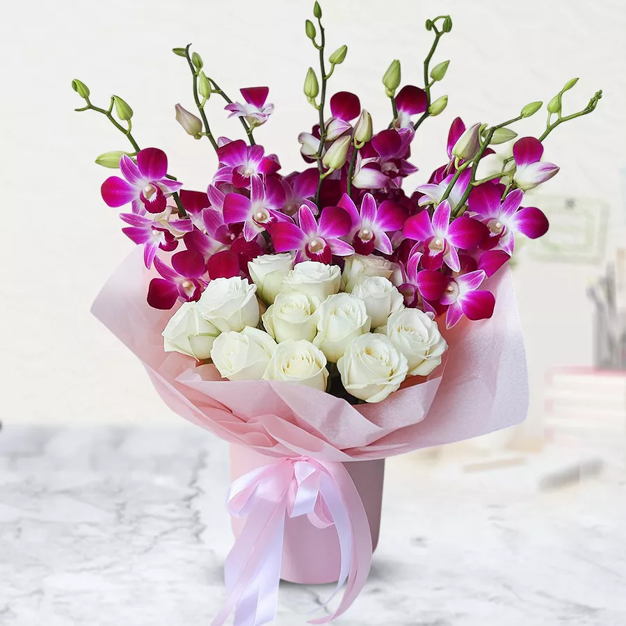 A beautiful bouquet featuring 10 orchids and 10 white roses, wrapped in delicate tissue.