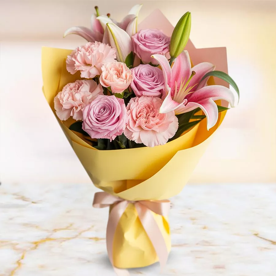 Cheerful Floral Harmony Gift featuring pink carnations, roses, and lilies in a beautiful arrangement.