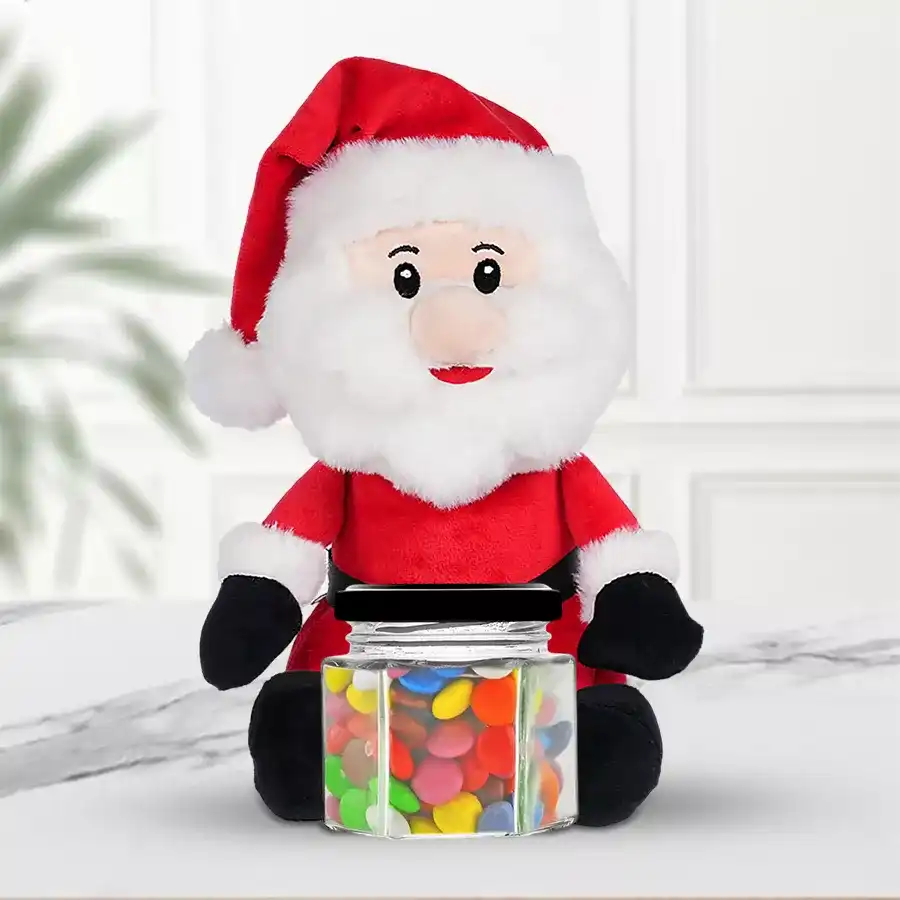 Christmas gift bundle for kids featuring an 8-inch Sitting Santa Claus soft toy and five packs of Cadbury Gems in a glass jar.