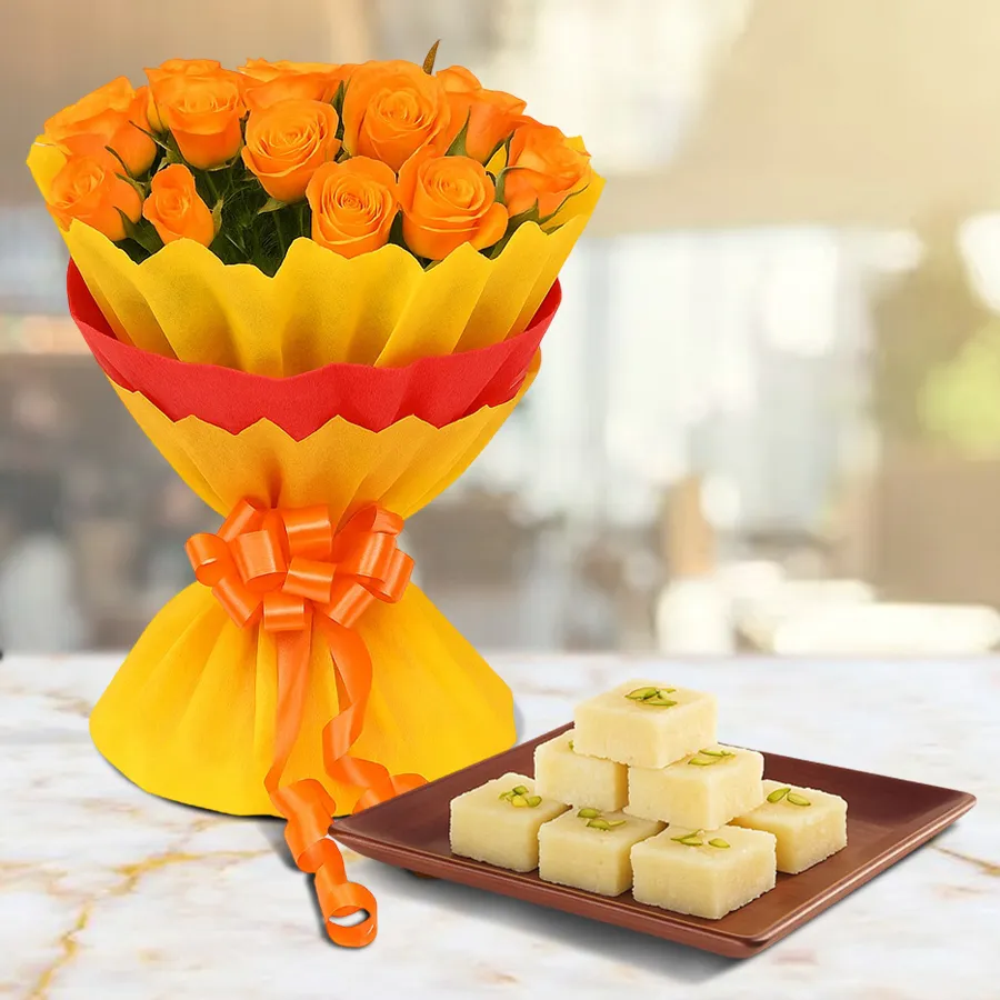 A beautiful bouquet of 15 orange roses wrapped in tissue, paired with 10 pieces of kalakand, ideal for gifts or personal enjoyment.