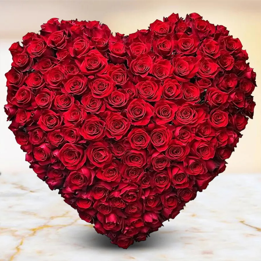 Heart-shaped arrangement of 150 red Dutch roses, symbolizing love and joy.