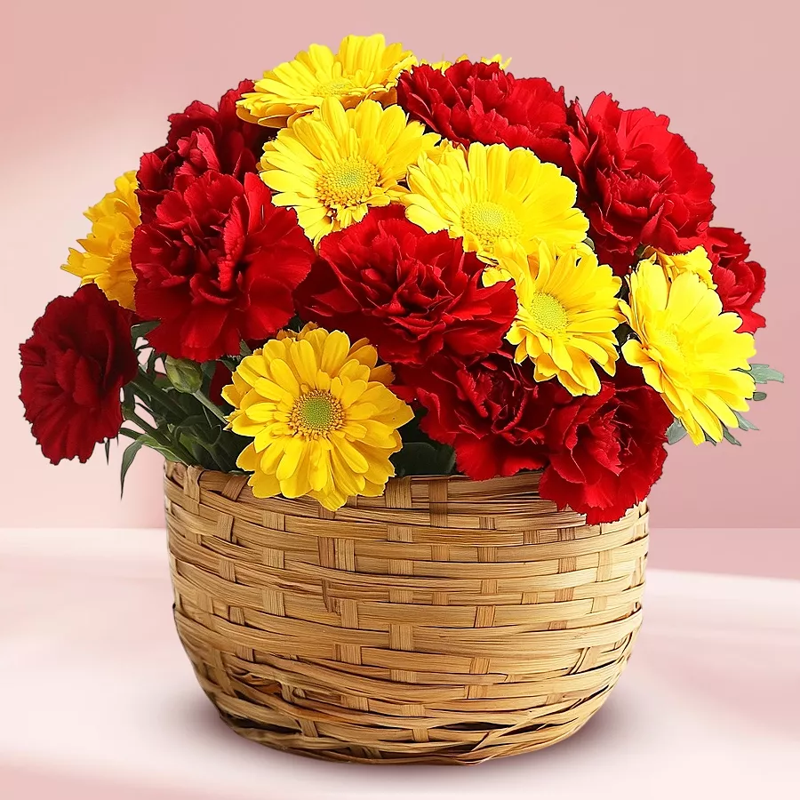 A vibrant arrangement of carnations and gerberas in a bamboo basket, radiating charm and elegance.