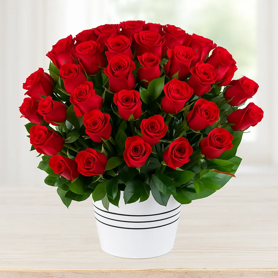 A lavish arrangement of 100 red Dutch roses alongside assorted Cadbury chocolates.
