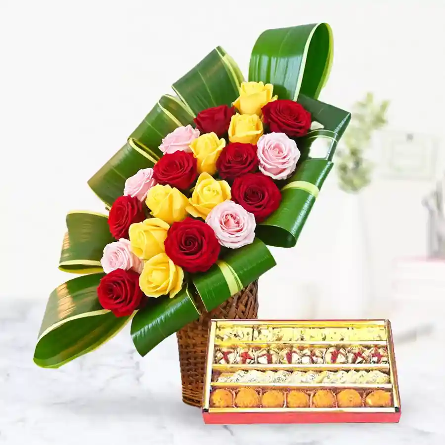 A beautiful arrangement of colorful mixed roses and an assortment of delicious sweets for a delightful gift.