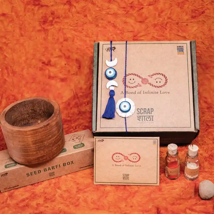 Green Bonds Rakhi Gift Box showcasing plantable rakhis, wooden planter, and traditional roli-chawal jars for sustainable celebrations.