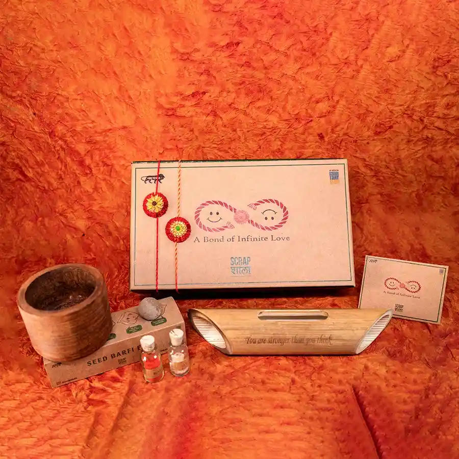 Eco-Chic Rakhi Celebration Set with plantable rakhis, bamboo amplifier, and wooden planter.