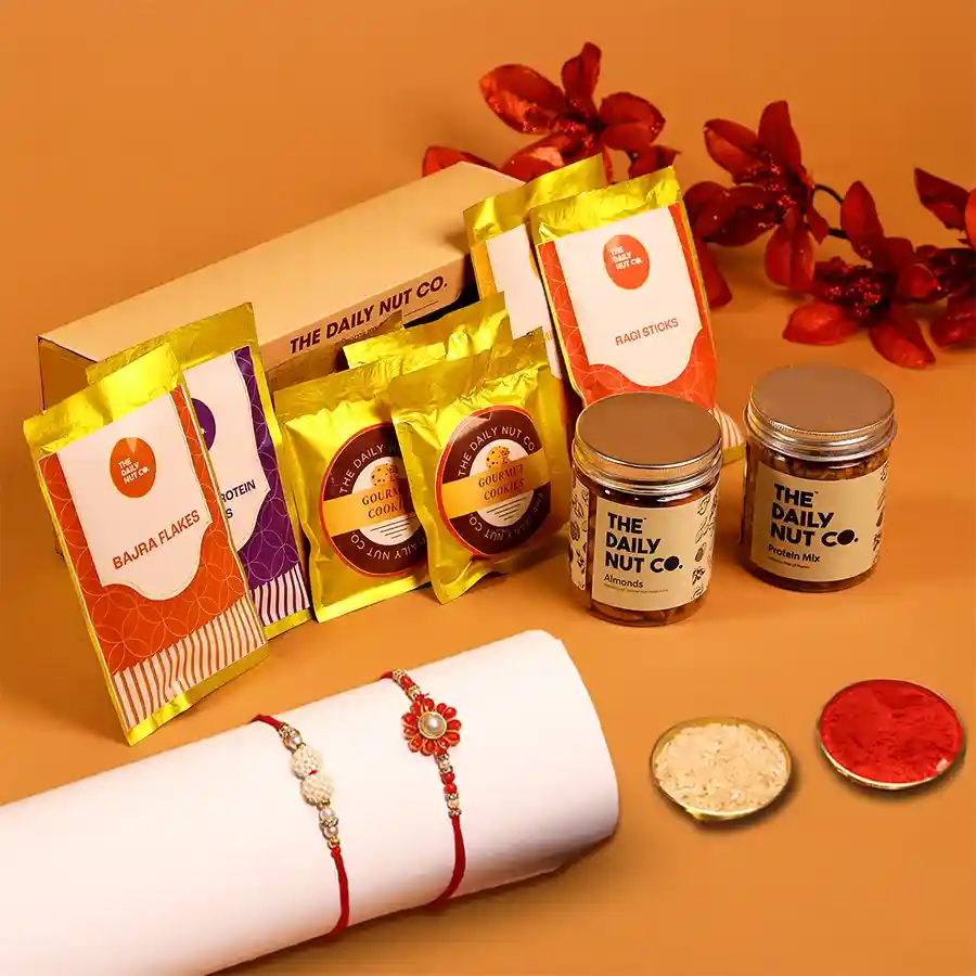Wholesome Rakhi Treats Gift Box with almonds, spiced raisins, cookies, and nutritious snacks in a festive gift box.