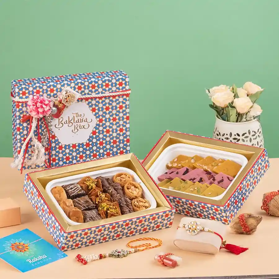 Elegant Rakhi Sweets Gift Box featuring designer Rakhis, gourmet Baklavas, and assorted flavored Katlis packaged beautifully.