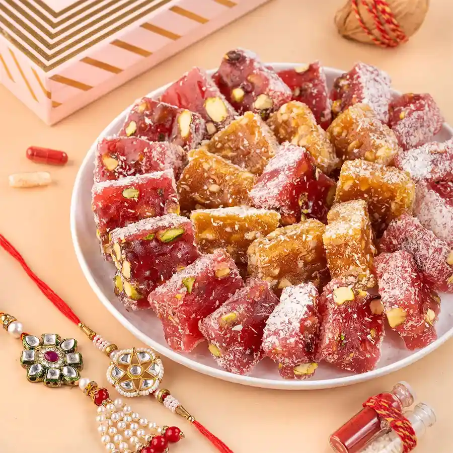 Gift box with Pomegranate Pistachio Turkish delight and Kundan Rakhis celebrating sibling bonds.