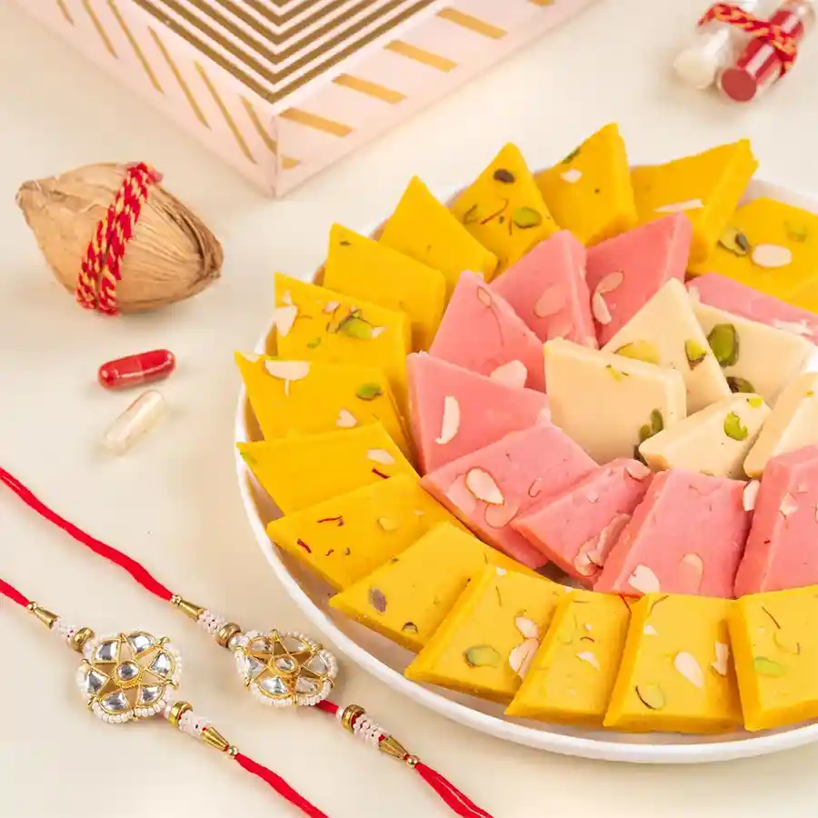 Exquisite Kaju Katli & Rakhi Duo featuring assorted sweets and handcrafted Rakhis.