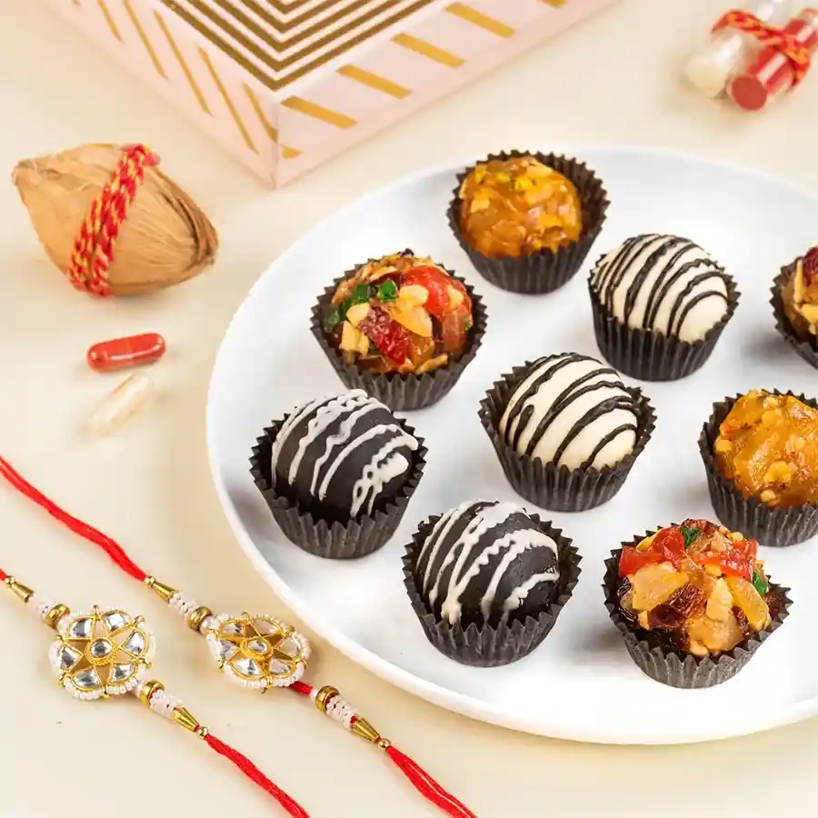 Rakhi & Fusion Laddu Delight gift box featuring assorted laddoos, Rakhis, and a greeting card for Raksha Bandhan celebration.