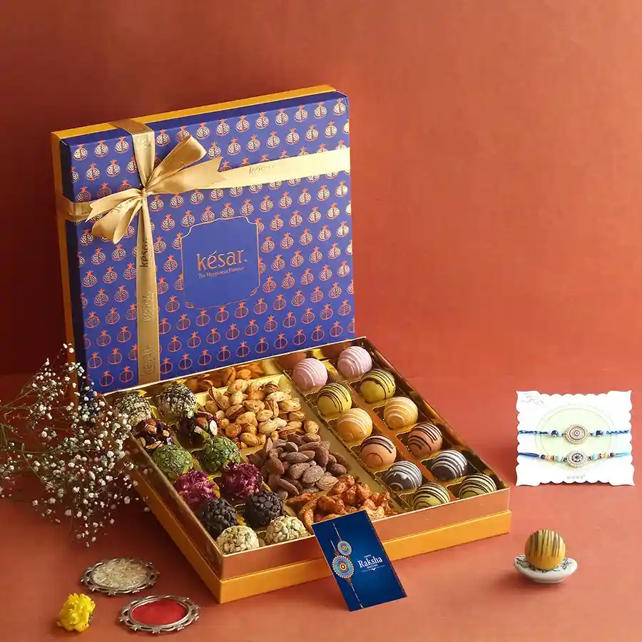Exquisite Rakhi & Treats Hamper featuring Rakhis and gourmet sweets.