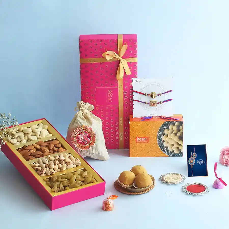 Divine Delights Rakhi Gift Hamper featuring Rakhis, nuts, handmade chocolates, and Desi Ghee Besan Laddoo in a beautifully arranged gift box.
