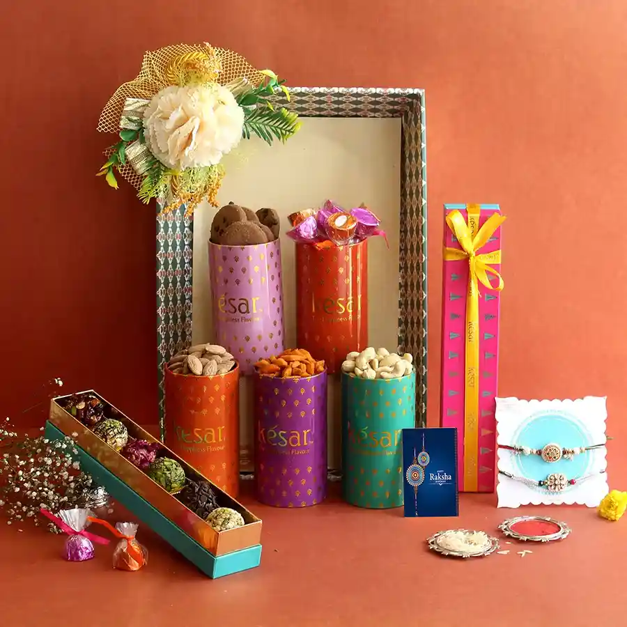 Rakhi Bliss Gift Ensemble featuring Rakhis, cookies, nuts, and gourmet sweets in a festive presentation.