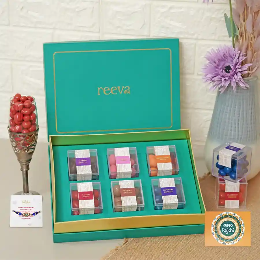 Colorful dragees assortment with an Evil Eye Rakhi in a festive hamper.