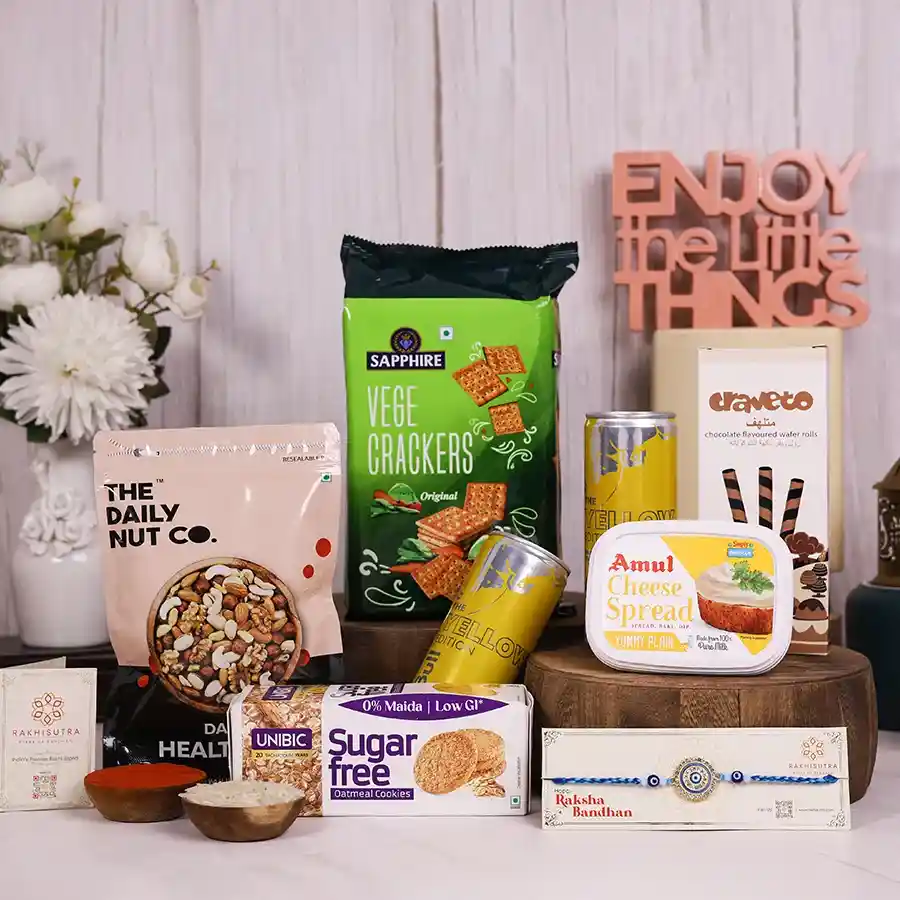 Rakhi Gourmet Goodies & Wishes Box with snacks and Rakhi for celebration.