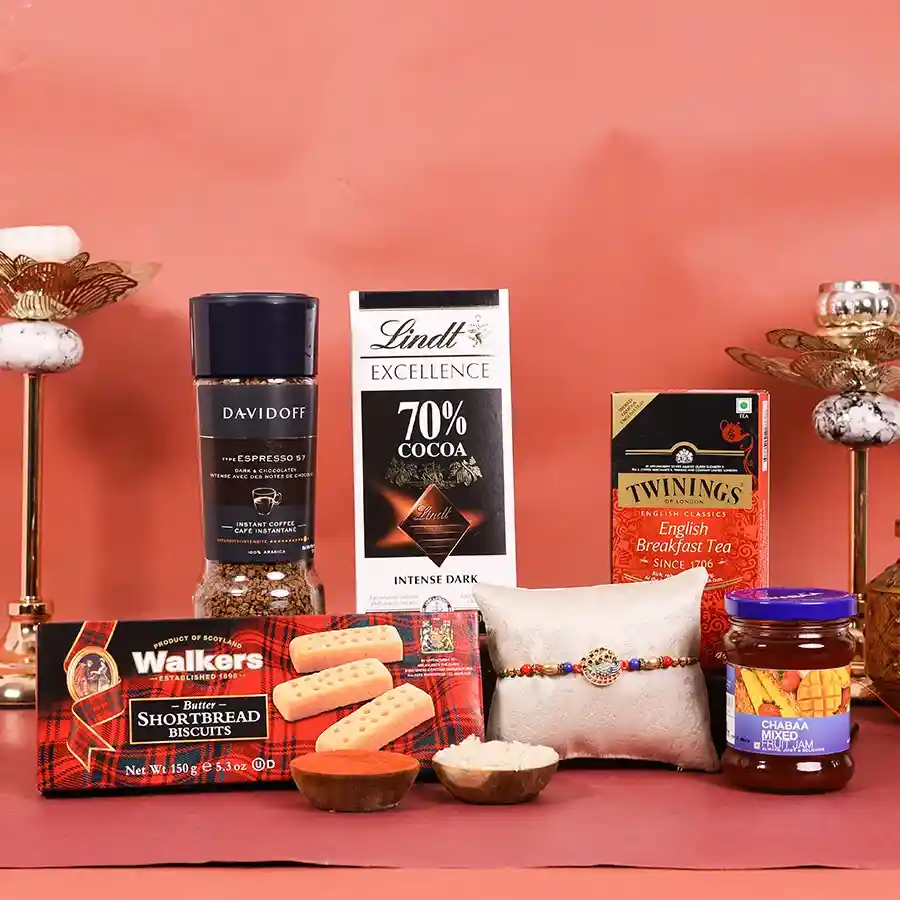 Sibling Love Rakhi Gourmet Gift Hamper featuring a designer Rakhi and delectable treats like chocolate, shortbread, tea, coffee, and a fruit spread.