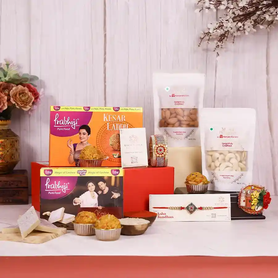 Regal Rakhi Celebration Box featuring Kundan Rakhi, Lumba Kada, assorted sweets, and a reusable gift box for Raksha Bandhan.