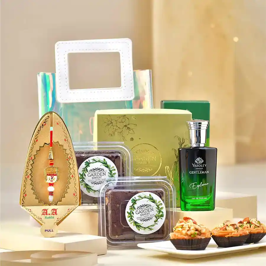 Exquisite Rakhi & Gourmet Goodies Hamper featuring a Meena Rakhi, baklava, brownies, perfume, and gift packaging.