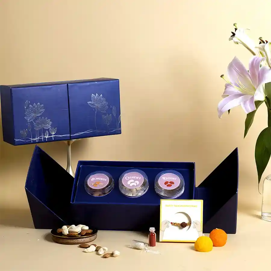 Heartfelt Nutri-Rich Rakhi Delight Pack with Rudraksha Rakhi, almonds, cashews, raisins, and a blue double door box.