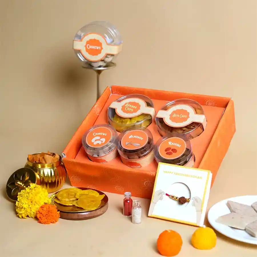 Flavorful Rakhi Nutri Gift Tray featuring a Rudraksha Rakhi and assorted crunchy snacks in a festive arrangement.