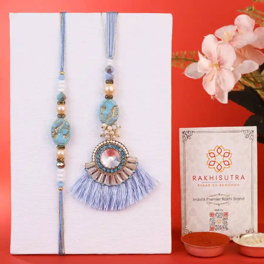 Beautiful Bhaiya Bhabi Rakhi Gift showcasing traditional rakhis with Roli, Tika, Chawal, and a heartfelt Message Card.