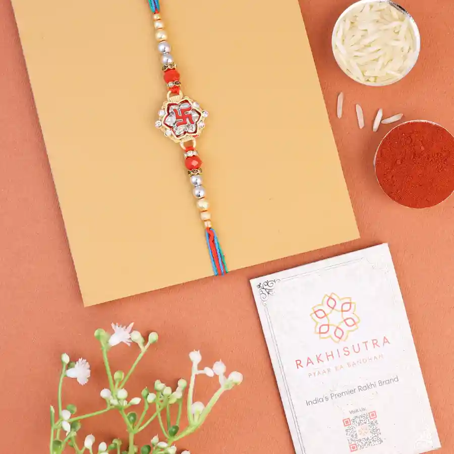 Kundan Swastik Rakhi set featuring roli tika and message card.
