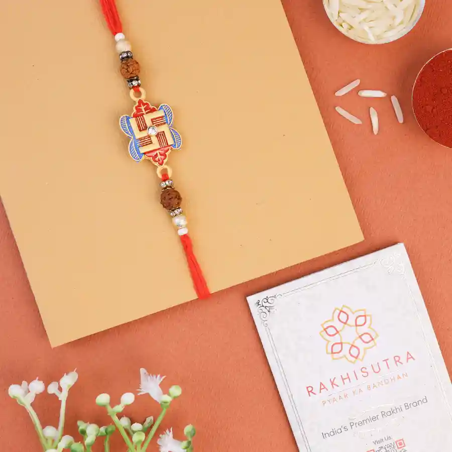 Symbolic Swastik Rakhi with roli tika and message card for Raksha Bandhan.