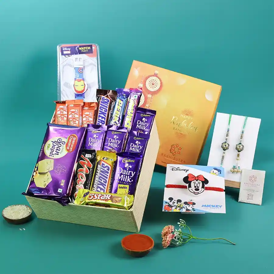 A festive gift box filled with Rakhis, sweets, and chocolates for Raksha Bandhan celebrations.