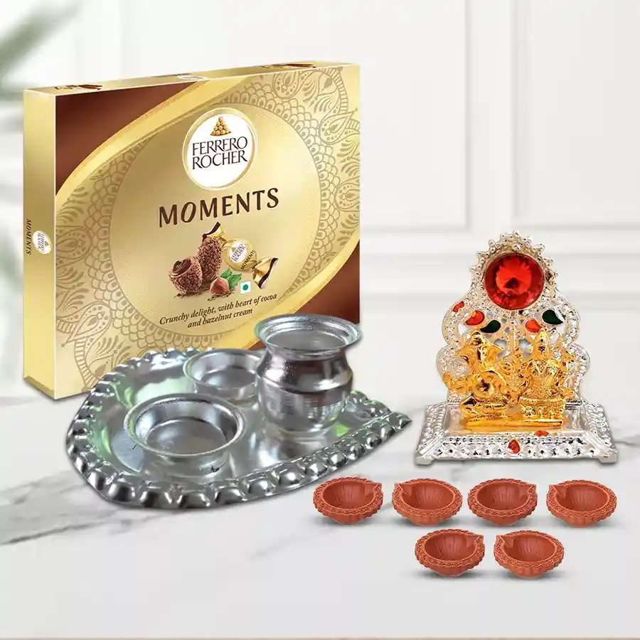 Diwali gift hamper featuring 24 Ferrero Rocher chocolates, a Ganesh-Laxmi Mandap, a silver-plated pooja thali shaped like a paan, and six decorative diyas.