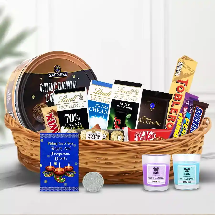 Marvelous Chocolates Gift Hamper for Diwali featuring premium chocolates, aroma candles, a Ganesh-Laxmi coin, and a greeting card in a stylish cane basket.