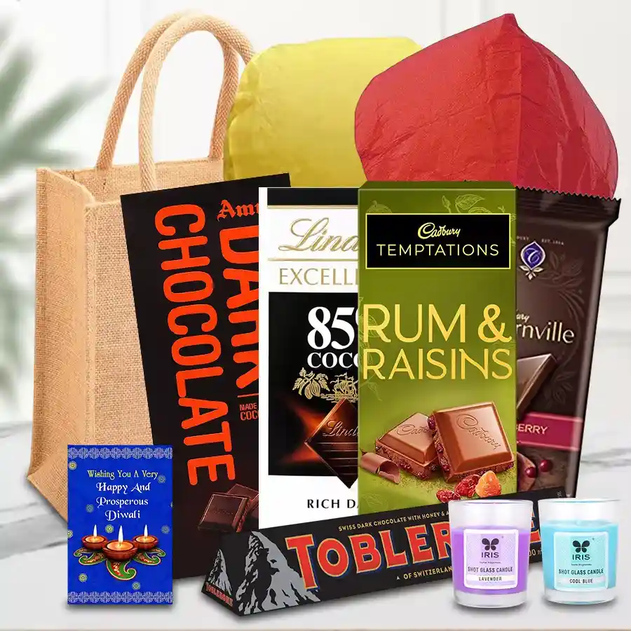 Amusing Chocolates Gift Hamper for Diwali featuring assorted chocolates, Iris glass candles, festive flying lanterns, and a jute gift bag with a Diwali card.