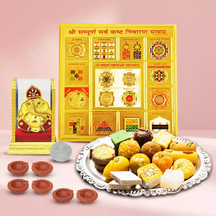 Divine Ganesh Murti with Sarva Kashta Nivaran Yantra Diwali Combo featuring antique brass Ganesh idol, yantra, assorted sweets, decorative mud diyas, and silver-plated coin