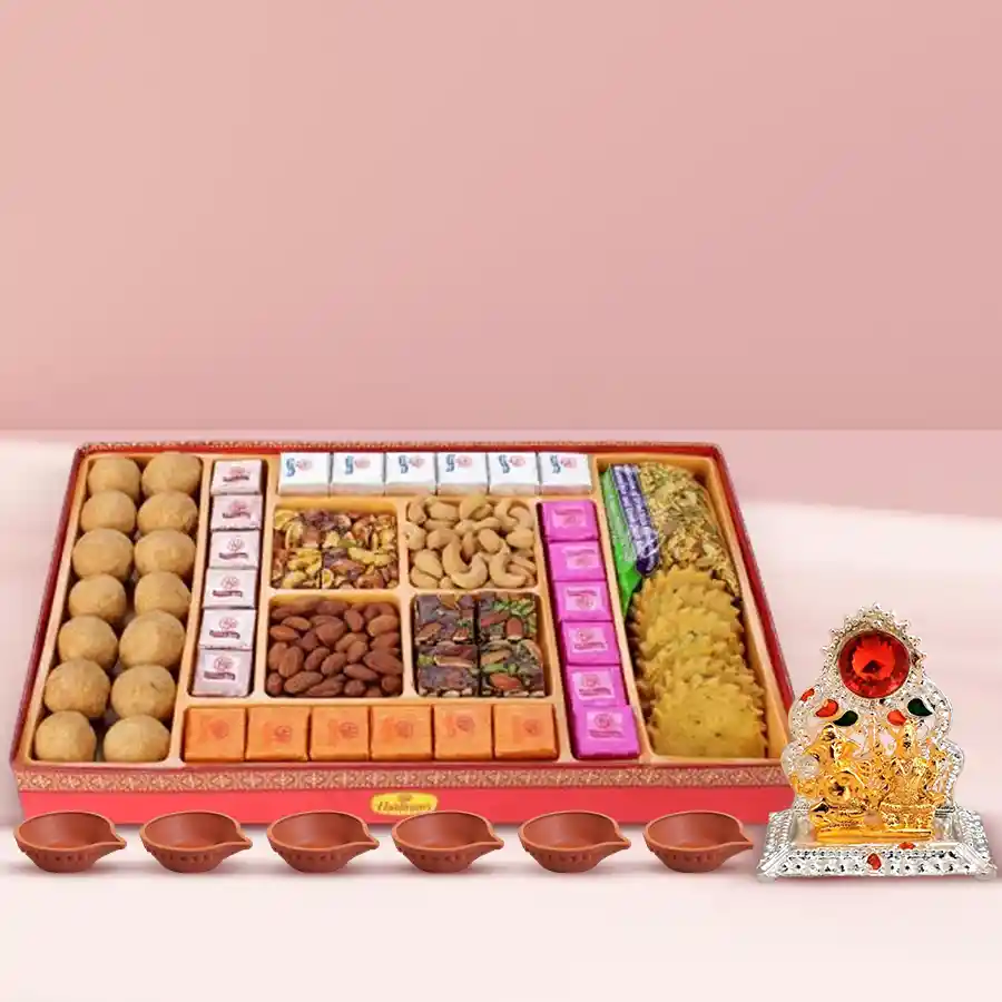 Magnificent Diwali Sweets and Snacks Combo featuring an antique Laxmi Ganesh Mandap, assorted treats, handmade chocolates, premium dry fruits, and 6 decorative diyas in a decorative tray.