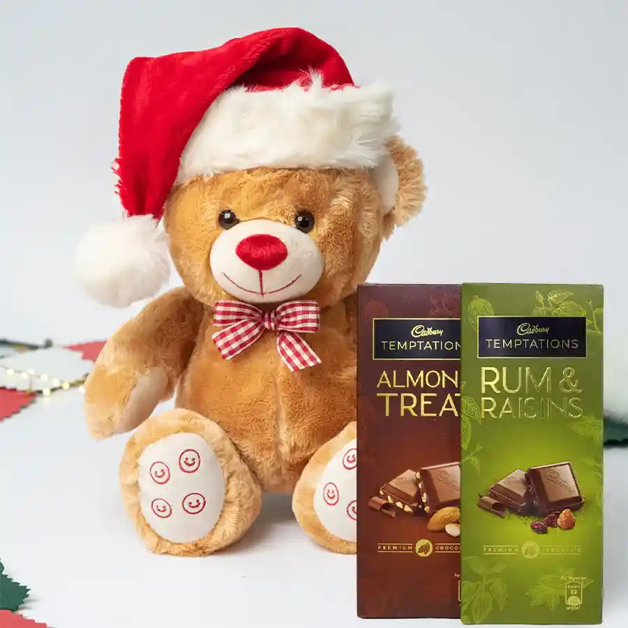 Remarkable Cadbury Temptations N Teddy Combo featuring two chocolate bars, a cuddly teddy bear, and a festive Santa Claus cap