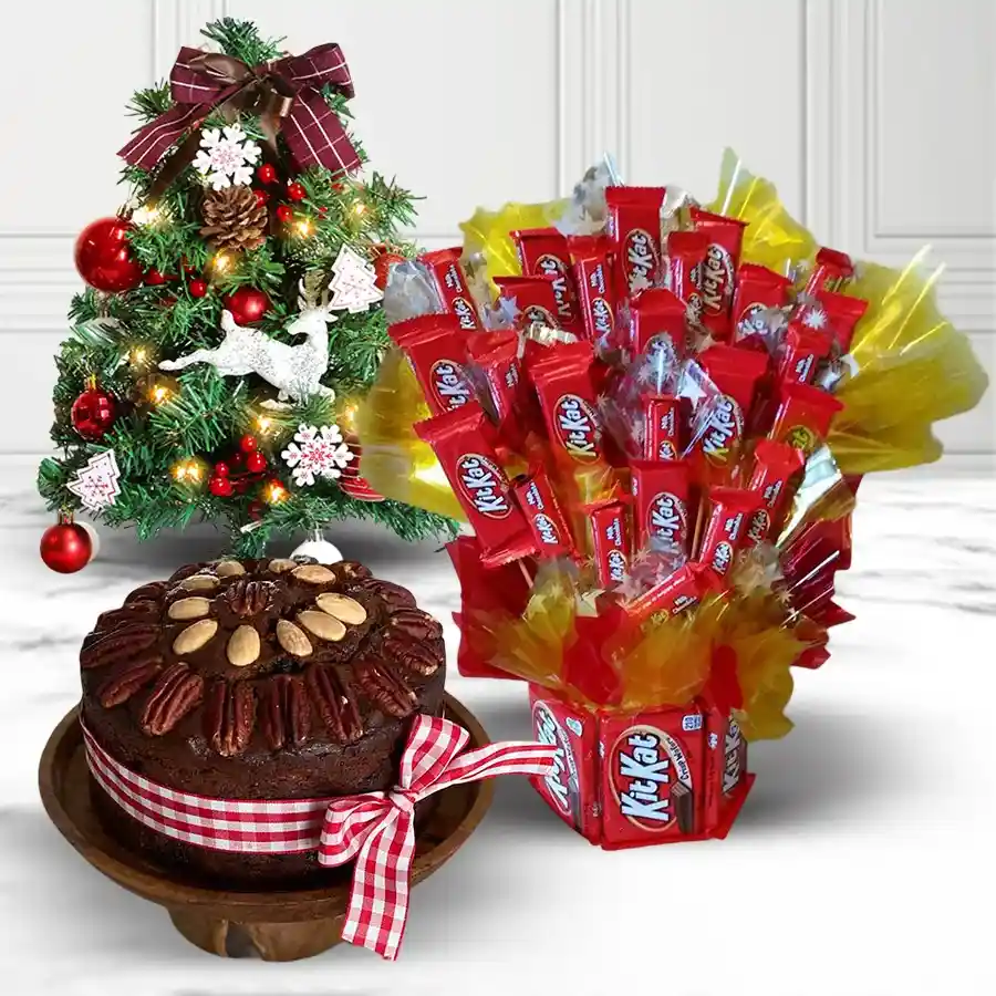 A festive KitKat bouquet featuring 32 Nestlé KitKat bars arranged with a 1-foot Christmas tree centerpiece and a delicious fruit cake, creating a cheerful holiday gift.