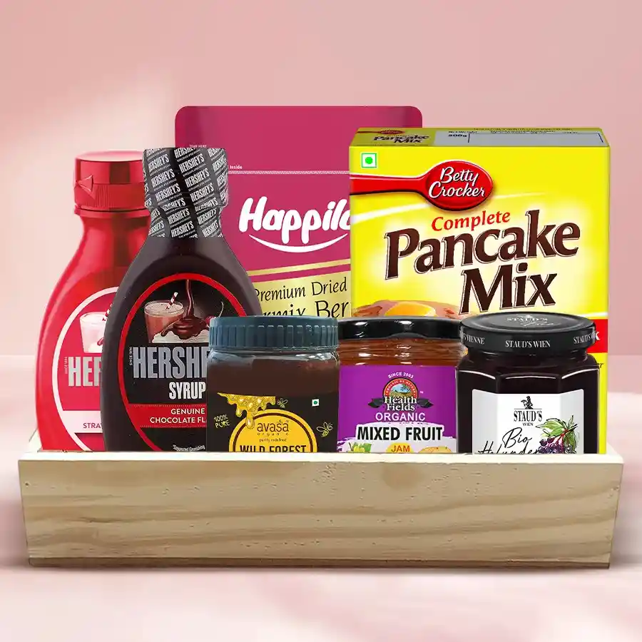 Marvelous Pancake and Breakfast Assortment Hamper with pancake mix, chocolate sauce, strawberry syrup, honey, jams, dried berry mix, and wooden tray