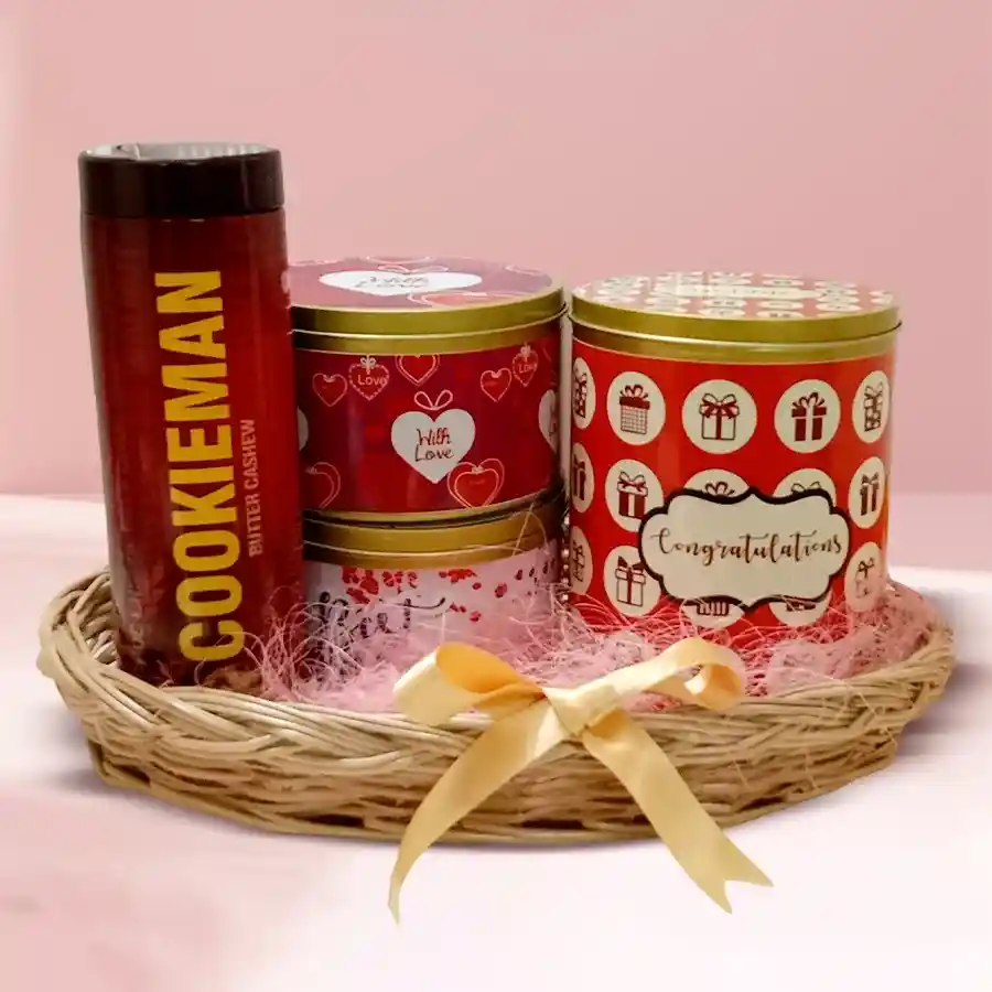 Wonderful Cookies Hamper for Christmas featuring four festive tin boxes filled with Chocochip, Sesame, Almond, and Fruit cookies in a decorated cane basket.