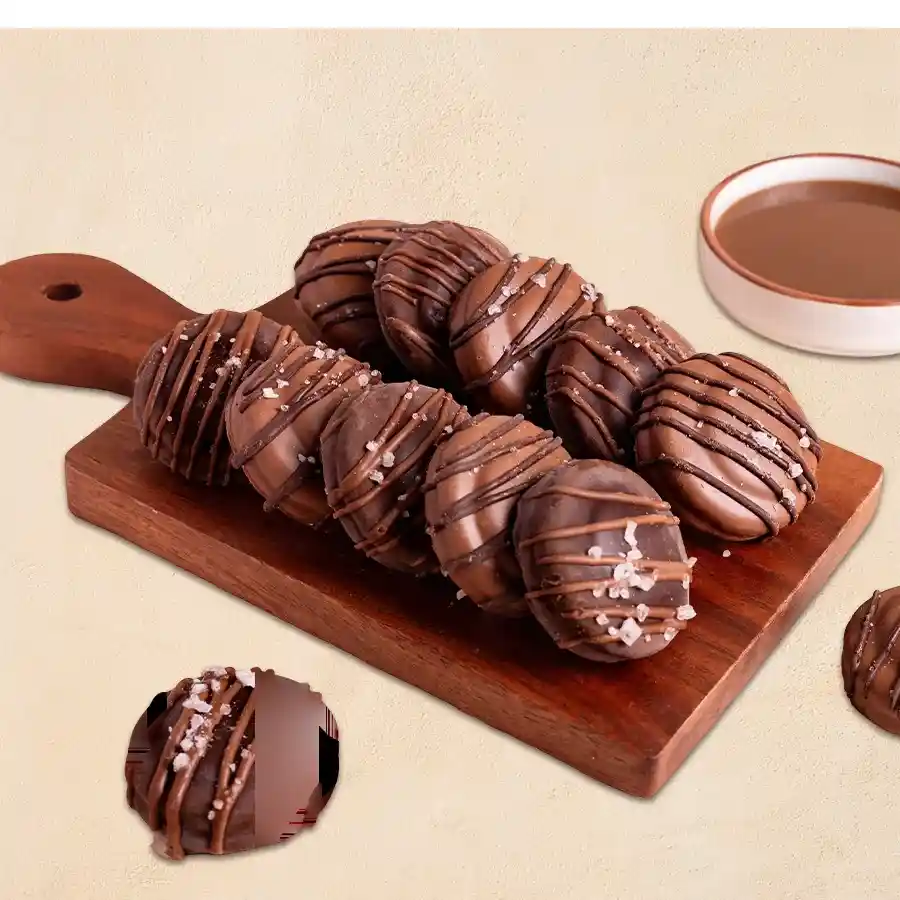 A beautifully arranged box of 12 Oreo cookies dipped in rich dark and creamy white Belgian chocolate, adorned with festive decorations.