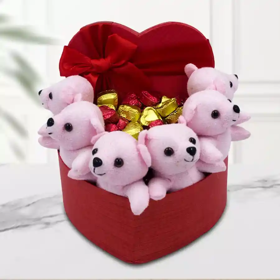 Heart-shaped box filled with teddy bears and heart-shaped chocolates