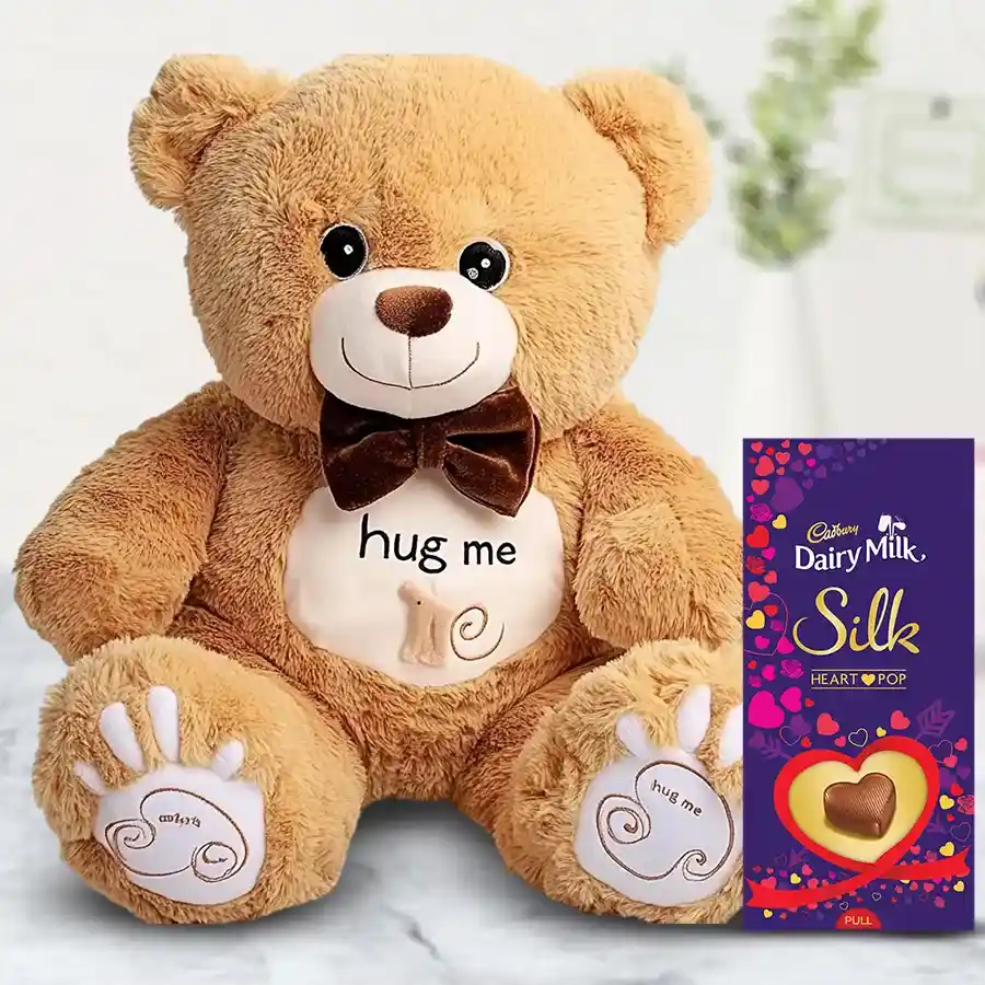 Exciting Teddy with a 160g Cadbury Silk Heart chocolate set, featuring a 40 cm cuddly teddy bear and heart-shaped chocolate packaging.