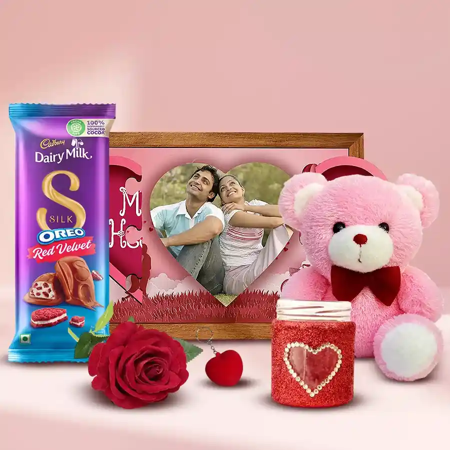 Tasty handmade chocolates, a magnetic heart, candles, a handmade Heart LED lamp, a velvet rose, a heart-shaped key ring, and a teddy bear arranged in a gift set for a birthday surprise.