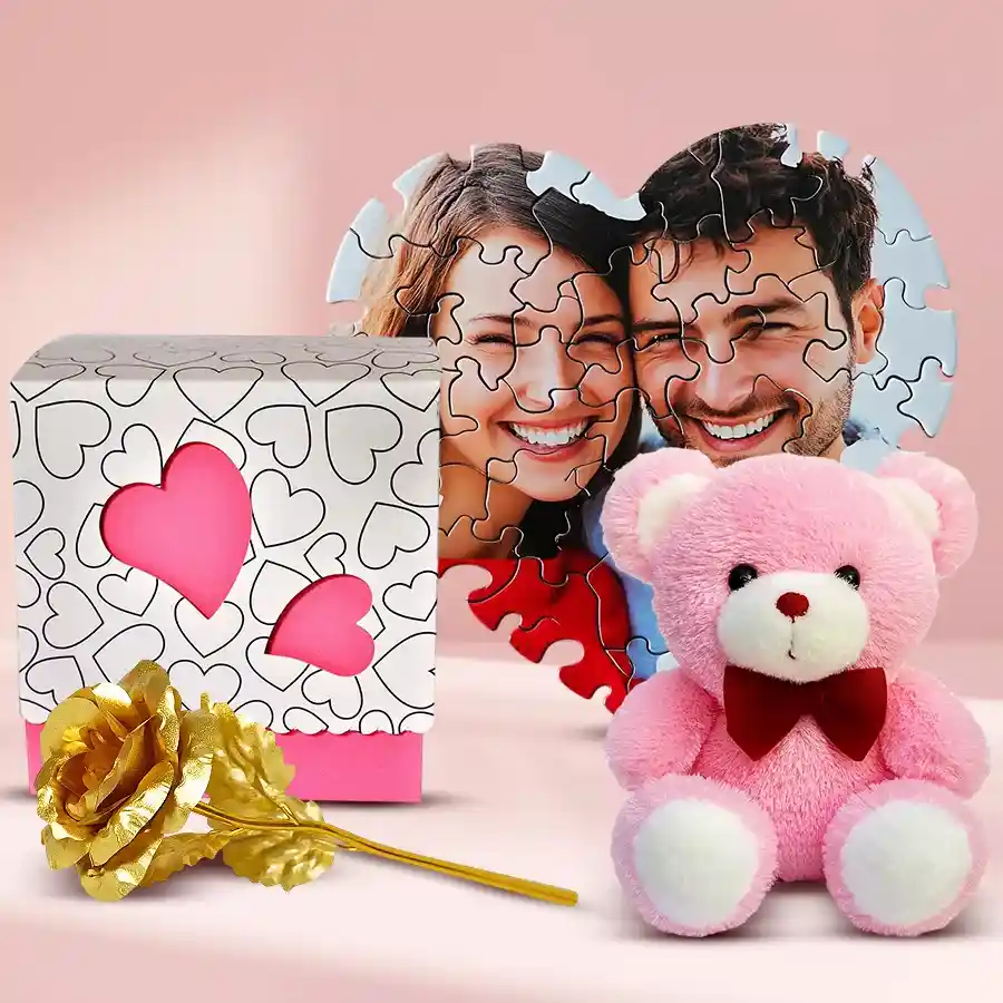 Mesmerizing Personalized Gift Combo featuring a heart-shaped puzzle, golden rose, handmade chocolate box with heart cutout, and a 6-inch teddy bear arranged beautifully.