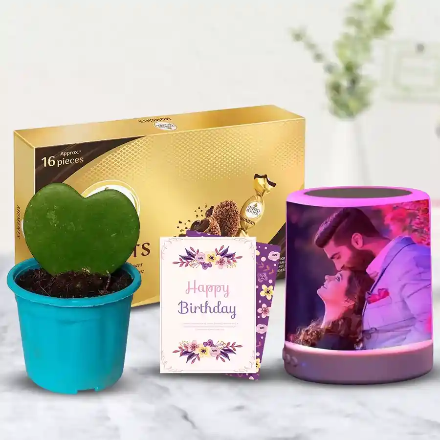 Personalized speaker, Ferrero Rocher chocolates, sweetheart plant, and birthday card arranged in a gift hamper